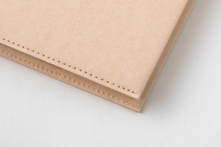 Beige A5 square notebook cover with decorative stitching along the edge