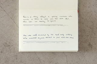 Handwritten note on paper, fountain pen ink text visible