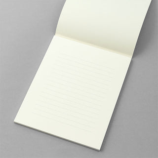 Cream lined letter paper sheet from pad, angled view