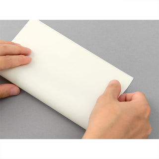 Cream envelope with flap, held open by hands