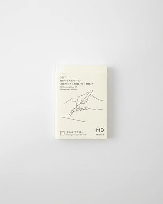 Monthly planner cover in cream with line-art design, text, and MD branding