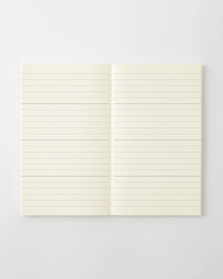 Monthly planner notebook open to lined pages with tabs, cream paper