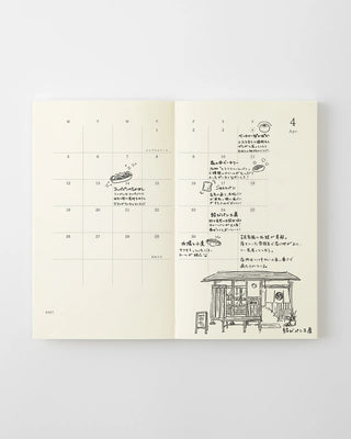 MD 2027 monthly planner notebook open to calendar page with notes and small illustration