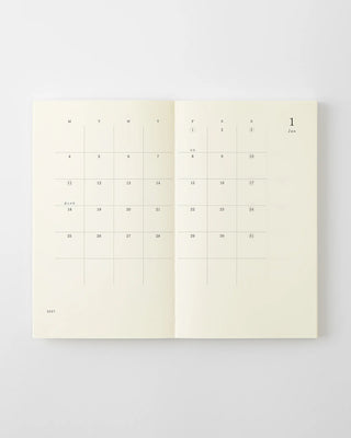MD 2027 monthly planner notebook open to calendar grid with dates and month header