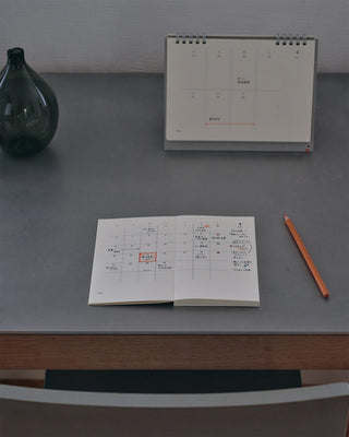 MD notebook monthly planner open to a chart page on a tabletop