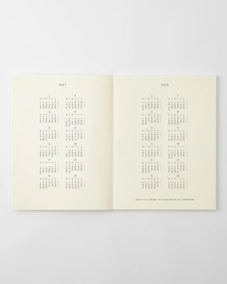 MD monthly calendar pages in an open notebook, dot grid layout for planning