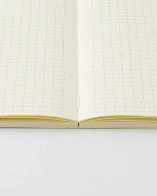 MD monthly planner open spread with grid paper and stitched binding at center