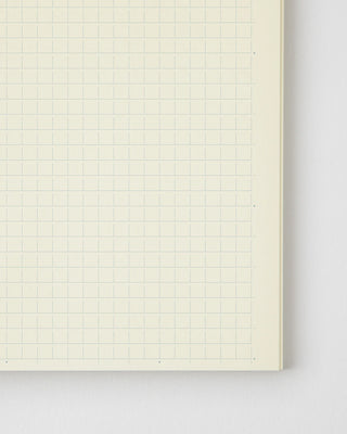 MD notebook monthly planner page close-up with light graph lines and date grid