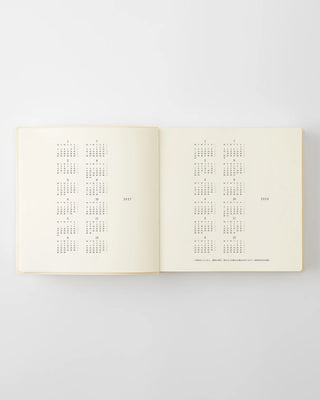 Open page-a-day planner showing a monthly calendar grid layout