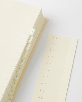 Open page-a-day planner with cream daily date grids and numbers