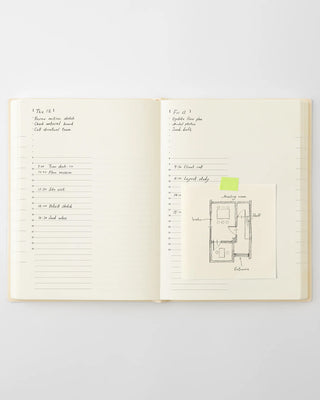Open page-a-day planner notebook with note lines and small floor plan sketch