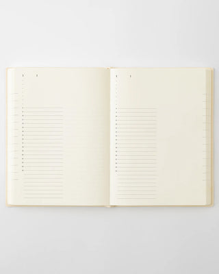 Open page-a-day planner notebook with ruled lines and dotted index strip