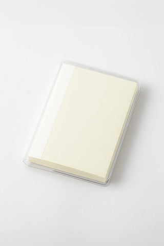 Clear-covered notebook with pale yellow pages and transparent edges.