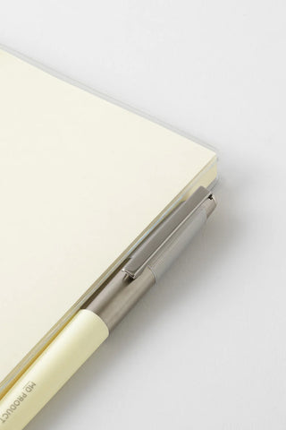 Clear cover with metal spine hardware and pale interior pages at the edge.