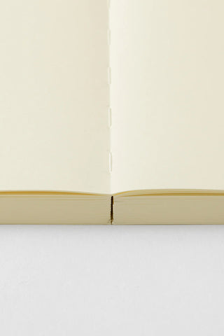 Open A5 journal notebook with cream page blocks and stitched binding