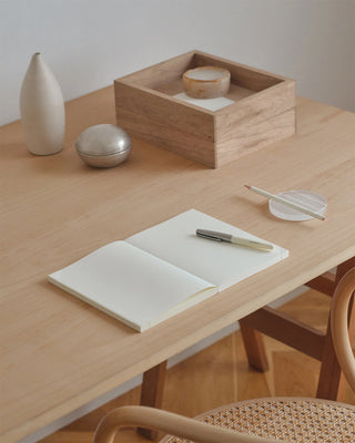 A5 page-a-day journal notebook, open on a light tabletop