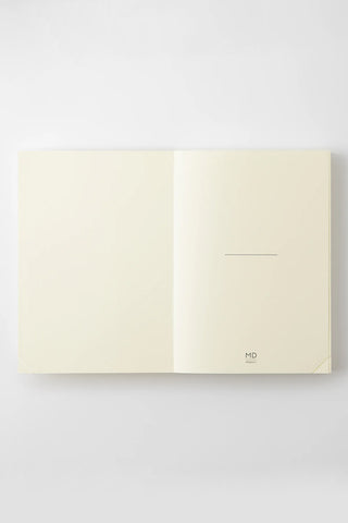 Open cream A5 journal notebook with one page having a small horizontal line