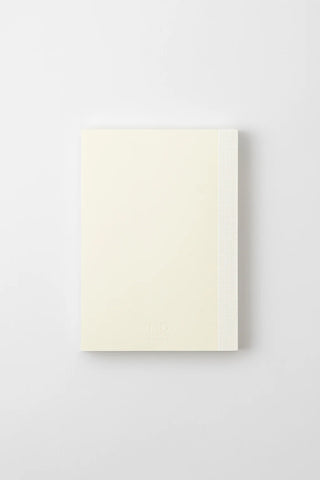 Cream notebook, closed front with subtle MD logo near bottom.