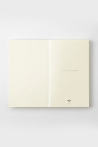Cream notebook opened, right panel shows thin horizontal line and MD logo near bottom.