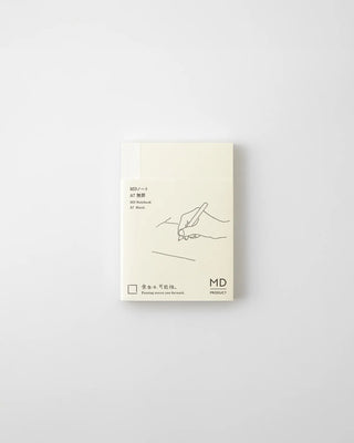 MD blank notebook with cream cover, line-art pen sketch, MD logo at bottom right.