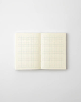 Open MD grid notebook, two grid-lined cream pages with faint margins
