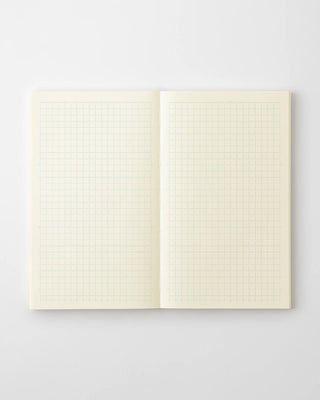 Open grid notebook with cream graph paper pages, centered spine view