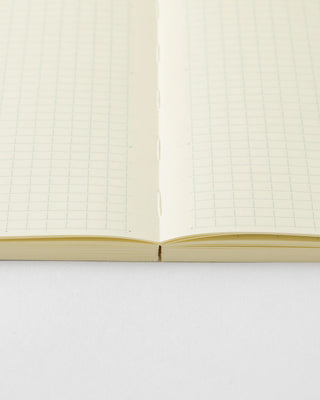Close-up of open MD grid notebook, pages split at the binding