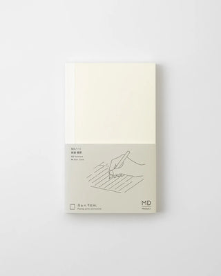 MD lined notebook closed, cream cover with writing illustration and small label.