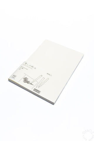 Thick cream notebook, closed cover with minimalist line art and dark printed details.