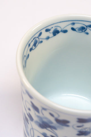 Blue floral pattern on inside rim of white ceramic mug
