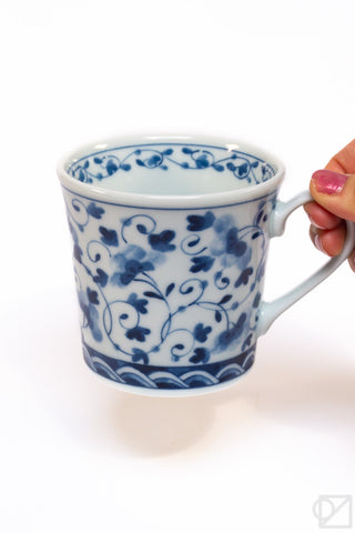 Blue-and-white floral ceramic mug, handle at right, view of rim