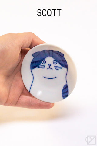 Ceramic cat face dish with blue-and-white cat face and whisker lines