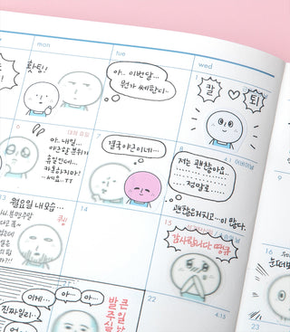 Calendar page covered with cute two-faced character stickers and comic-style bubbles