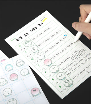 Sticker sheet laid out with round faces, some green and pink character stickers