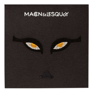 Embroidered eye patches with black fabric and bright orange-gold pupils