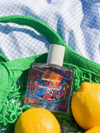 Eau de parfum bottle with cork-style cap and red-blue decorative label