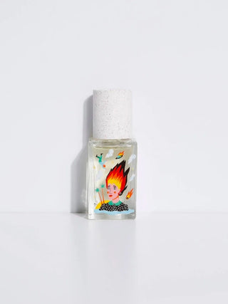 Perfume bottle with white speckled cap and colorful illustrated label, square glass.