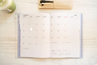 Monthly planner spread with dated blocks and red weekday bars, 2027