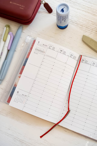 A6 weekly vertical planner refill open to a weekly date grid with red underline
