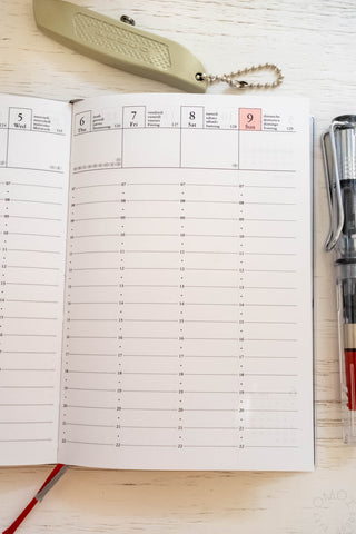 Open A6 weekly planner pages with dated weekly schedule grid