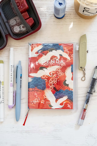 A5 weekly vertical planner with red bird and wave cover design, 'AGENDA' text.
