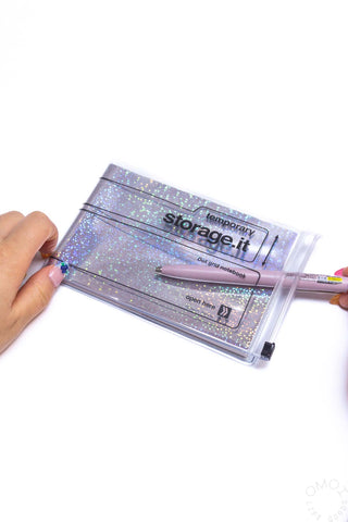 Holographic speckle landscape dot grid notebook held by hand with clear clasp