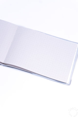 Close-up of open landscape dot grid notebook with dotted inner pages