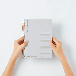 A5 spiral notebook, hands holding white cover with ruled panel and copper rings