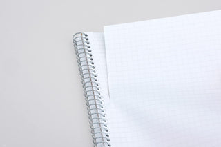 B5 spiral notebook close-up of metal rings and squared grid page