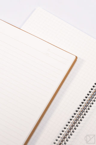 A5 spiral ring notebook open to light gray grid paper