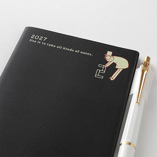 Black leather-look 2027 planner cover with engraved texture and nutcracker-style icon