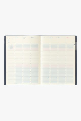 Open vertical weekly planner pages with date grid lines on cream paper