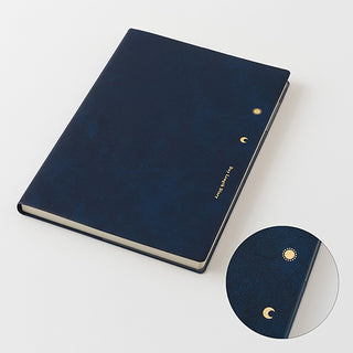 Dark blue planner cover with gold ring and moon symbols; inset close-up detail