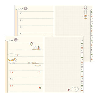 Open planner with monthly layout and cat illustrations along the margins.